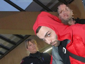 Calgary Police along with the Guns and Gangs Unit take Tarek El-Rafie, 24 into custody at the Calgary International Airport in a file photo from November 2015.