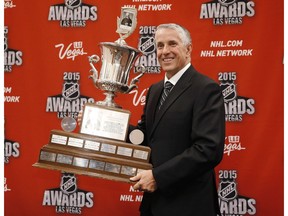 FILE - In this June 24, 2015 file photo, Calgary Flames coach Bob Hartley poses with the Jack Adams Award trophy after winning the award at the NHL Awards show in Las Vegas. The Calgary Flames have fired Bob Hartley, who was the named the NHL's coach of the year last season.