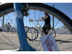 First time cyclist Stephanie Lam learns to ride a bike during a bike riding course in Calgary, Alta., on Saturday May 7, 2016. Leah Hennel/Postmedia