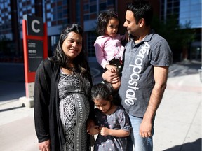 Fort McMurray evacuees Saira and Furqan Younis with their children Inaya, 5, and Zunaira, 3, at the evacuee reception area at SAIT in Calgary, Alta., on Friday May 6, 2016. Leah Hennel/Postmedia