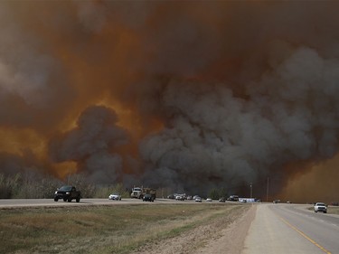 Residents of Fort McMurray flee southbound on Highway 63 Tuesday. Wildfires forced the evacuation of the city Tuesday as high temperatures and winds continued to batter the region.