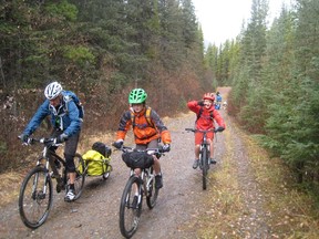 From left: Robin Borstmayer, Finn Borstmayer and Clay Milne lead the pack as the group rides toward Cascade Creek for a snack break and some big stone throwing.