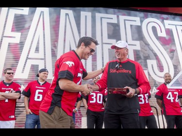 Fullback Rob Cote receives the President's Ring from team president and GM John Hufnagel during the Calgary Stampeders Fanfest at McMahon Stadium in Calgary, Alta., on Saturday, May 14, 2016. The event featured player autographs, a pancake breakfasts and family games. Lyle Aspinall/Postmedia Network