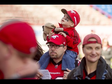 Gary Dormer holds his son Blake Dormer, 3, during the Calgary Stampeders Fanfest at McMahon Stadium in Calgary, Alta., on Saturday, May 14, 2016. The event featured player autographs, a pancake breakfasts and family games. Lyle Aspinall/Postmedia Network