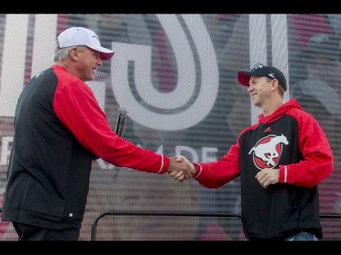 Team president and general manager John Hufnagel (L) shakes hands with new head coach Dave Dickenson during the Calgary Stampeders Fanfest at McMahon Stadium in Calgary, Alta., on Saturday, May 14, 2016. The event featured player autographs, a pancake breakfasts and family games. Lyle Aspinall/Postmedia Network
