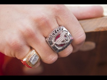 Rob Cote's President's Ring (L) is dwarfed by his Grey Cup ring from the 2014 season during the Calgary Stampeders Fanfest at McMahon Stadium in Calgary, Alta., on Saturday, May 14, 2016. The event featured player autographs, a pancake breakfasts and family games. Lyle Aspinall/Postmedia Network