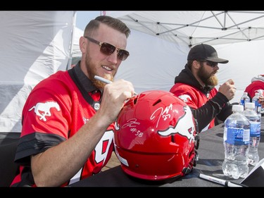 Quarterback Bo Levi Mitchell signs an autograph during the Calgary Stampeders Fanfest at McMahon Stadium in Calgary, Alta., on Saturday, May 14, 2016. The event featured player autographs, a pancake breakfasts and family games. Lyle Aspinall/Postmedia Network