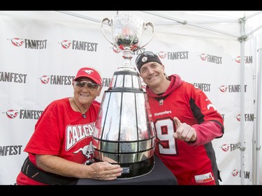 Jason Gordon and his mom Carmen Miller mug for a photo with the Grey Cup during the Calgary Stampeders Fanfest at McMahon Stadium in Calgary, Alta., on Saturday, May 14, 2016. The event featured player autographs, a pancake breakfasts and family games. Lyle Aspinall/Postmedia Network