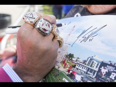 Rings adorn the fingers of recently retired star Jon Cornish during the Calgary Stampeders Fanfest at McMahon Stadium in Calgary, Alta., on Saturday, May 14, 2016. The event featured player autographs, a pancake breakfasts and family games. Lyle Aspinall/Postmedia Network