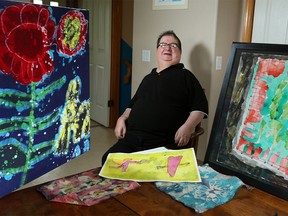 Joseph Hnatuk, an artist suffering from schizophrenia, poses with some of his art on Monday May 23, 2016. Hnatuk will be the featured artist at the Splash of Colour art show on May 29 at Optimist Gallery, In-Definite Arts. A portion of the proceeds from the show will be going toward Vecova to help those with disabilities.