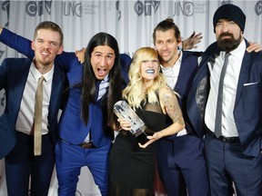 Canadian alternative rock band, Walk Off The Earth pose with their Juno after winning the Group of the Year at the 2016 JUNO Awards in Calgary, Alta., on Sunday, April 3, 2016. They'll return to the city to perform on the Coca-Cola Stage during this year's Calgary Stampede.
