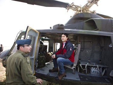 Prime Minister Justin Trudeau takes a helicopter tour of the devastation during a visit to Fort McMurray, Alta., on Friday, May 13, 2016, to see first-hand the devastation caused by the wildfire that forced the evacuation of the city.