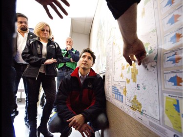 Prime Minister Justin Trudeau is given a briefing at the Regional Emergency Operation Centre during a visit to Fort McMurray, Alta., on Friday, May 13, 2016, to see first-hand the devastation caused by the wildfire that forced the evacuation of the city.