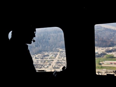 Prime Minister Justin Trudeau takes a helicopter tour of the devastation during a visit to Fort McMurray, Alta., on Friday, May 13, 2016, to see first-hand the devastation caused by the wildfire that forced the evacuation of the city.