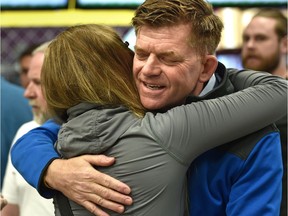Wildrose Leader Brian Jean gets a hug while talking to evacuees at the evacuation centre in Lac La Biche on Monday.