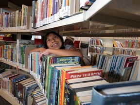 Leeann Gomez,9, checks out some of the new books as The Calgary Public Library unveiled the newly renovated Forest Lawn Library in this November 2015 file photo.