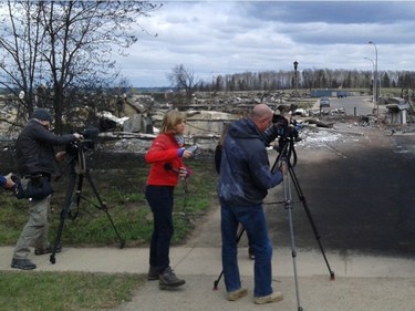 Media tour the burned out neighbourhood Beacon Hill in Fort McMurray, Alberta where wildfires have ravaged the area.  Tristin Hopper/National Post