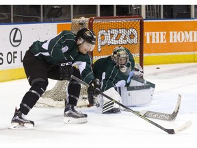 London Knights goaltender Tyler Parsons tracks the puck as forward Max Jones rounds his net during a team hockey practice at Budweiser Gardens in London, Ont. on Tuesday. The Knights head coach, Dale Hunter, and Red Deer Rebels head coach Brett Sutter did battle many times as opposing NHL centres.