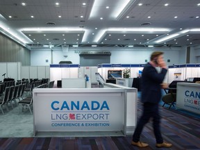 A man speaks on his phone while attending the Canada LNG Export Conference & Exhibition in Vancouver, B.C., on Thursday May 12, 2016.