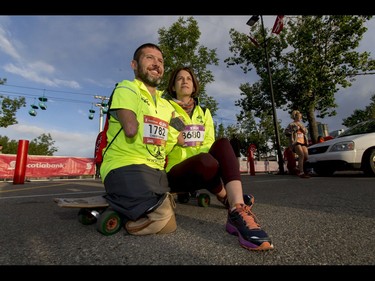 Chris Koch and his girlfriend Ally Iseman sit for a photo before start of the Calgary Marathon at the Stampede Grounds in Calgary, Alta., on Sunday, May 29, 2016. Koch, whose arms stop at the elbow and who has no legs, would go on to finish a full 42.2-km marathon. There were 5k, 10k, 21.1k, 42.2k and 50k distances in the race, including the half-marathon national championships. Lyle Aspinall/Postmedia Network