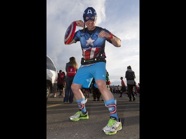 David Tillett strikes an Ironman pose while warming up for the Calgary Marathon at the Stampede Grounds in Calgary, Alta., on Sunday, May 29, 2016. There were 5k, 10k, 21.1k, 42.2k and 50k distances in the race, including the half-marathon national championships. Lyle Aspinall/Postmedia Network