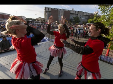 Goodlife Fitness warmup dancers Lindsay Cook, Renée Maygard, Lou Hagen and Kirsten Dutchak high-five before the start of the Calgary Marathon at the Stampede Grounds in Calgary, Alta., on Sunday, May 29, 2016. There were 5k, 10k, 21.1k, 42.2k and 50k distances in the race, including the half-marathon national championships. Lyle Aspinall/Postmedia Network