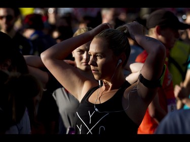 Shaylee Buehler pins her hair back before the start of the Calgary Marathon at the Stampede Grounds in Calgary, Alta., on Sunday, May 29, 2016. There were 5k, 10k, 21.1k, 42.2k and 50k distances in the race, including the half-marathon national championships. Lyle Aspinall/Postmedia Network