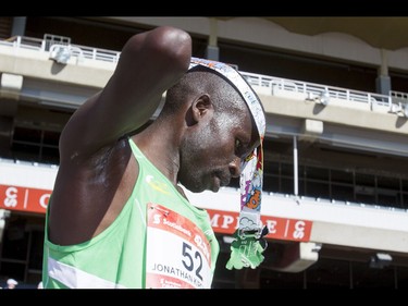 Jonathan Kipchirchir Chesoo of Kenya dons his medal after winning the Calgary Marathon at the Stampede Grounds in Calgary, Alta., on Sunday, May 29, 2016. There were 5k, 10k, 21.1k, 42.2k and 50k distances in the race, including the half-marathon national championships. Lyle Aspinall/Postmedia Network