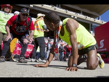 Gelaw Siraw rests after finishing third in the Calgary Marathon at the Stampede Grounds in Calgary, Alta., on Sunday, May 29, 2016. There were 5k, 10k, 21.1k, 42.2k and 50k distances in the race, including the half-marathon national championships. Lyle Aspinall/Postmedia Network