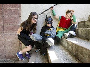 Ava Lang, 9, and her brothers Roman, 7, and Maksim, 6, take a break in a stairwell during the Calgary Marathon at the Stampede Grounds in Calgary, Alta., on Sunday, May 29, 2016. There were 5k, 10k, 21.1k, 42.2k and 50k distances in the race, including the half-marathon national championships. Lyle Aspinall/Postmedia Network