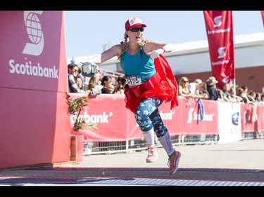 Sarah Hatt finishes the women's half-marathon in style during the Calgary Marathon at the Stampede Grounds in Calgary, Alta., on Sunday, May 29, 2016. There were 5k, 10k, 21.1k, 42.2k and 50k distances in the race, including the half-marathon national championships. Lyle Aspinall/Postmedia Network