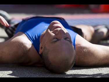 Steve Gray lays on asphalt after tripping at the finish line in the Calgary Marathon at the Stampede Grounds in Calgary, Alta., on Sunday, May 29, 2016. There were 5k, 10k, 21.1k, 42.2k and 50k distances in the race, including the half-marathon national championships. Lyle Aspinall/Postmedia Network