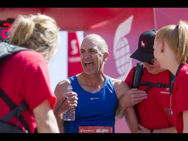 Steve Gray has a laugh after tripping at the finish line in the Calgary Marathon at the Stampede Grounds in Calgary, Alta., on Sunday, May 29, 2016. There were 5k, 10k, 21.1k, 42.2k and 50k distances in the race, including the half-marathon national championships. Lyle Aspinall/Postmedia Network