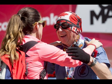 Marathon legend Martin Parnell greets race executive director Kirsten-Ellen Fleming after completing the Calgary Marathon at the Stampede Grounds in Calgary, Alta., on Sunday, May 29, 2016. There were 5k, 10k, 21.1k, 42.2k and 50k distances in the race, including the half-marathon national championships. Lyle Aspinall/Postmedia Network