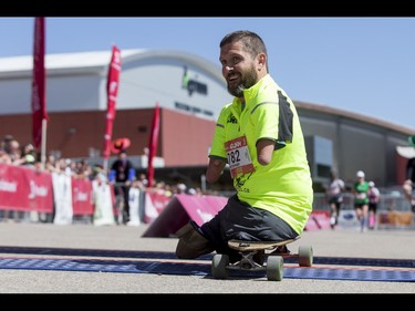 Chris Koch crosses the finish line of the Calgary Marathon at the Stampede Grounds in Calgary, Alta., on Sunday, May 29, 2016. There were 5k, 10k, 21.1k, 42.2k and 50k distances in the race, including the half-marathon national championships. Lyle Aspinall/Postmedia Network