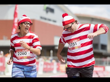 Sarah Akierman and Paul Kanciar, complete with 'Where's Waldo' charm, happily finish the Calgary Marathon at the Stampede Grounds in Calgary, Alta., on Sunday, May 29, 2016. There were 5k, 10k, 21.1k, 42.2k and 50k distances in the race, including the half-marathon national championships. Lyle Aspinall/Postmedia Network