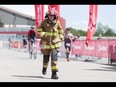 Olds firefighter Noel Darcy runs to the finish line while completing the Calgary Marathon at the Stampede Grounds in Calgary, Alta., on Sunday, May 29, 2016. Darcy wore full firefighting gear for the entire 42.2-km distance, and finished in a time of 5:25:03. There were 5k, 10k, 21.1k, 42.2k and 50k distances in the race, including the half-marathon national championships. Lyle Aspinall/Postmedia Network