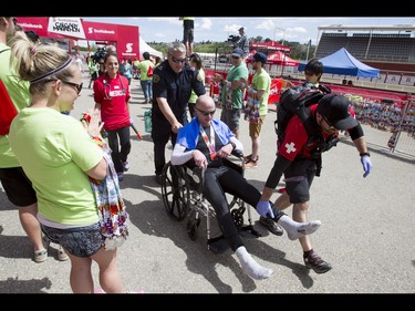 Olds firefighter Noel Darcy is immediately rushed to a medical stent after completing the Calgary Marathon in his full firefighter outfit at the Stampede Grounds in Calgary, Alta., on Sunday, May 29, 2016. Darcy wore full firefighting gear for the entire 42.2-km distance, and finished in a time of 5:25:03. There were 5k, 10k, 21.1k, 42.2k and 50k distances in the race, including the half-marathon national championships. Lyle Aspinall/Postmedia Network