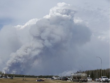 A massive wildfire is seen from the corner of Highway 63 and Highway 881, Alta., on Wednesday May 4, 2016. A massive evacuation of Fort McMurray was held after a large wildfire struck the city. Photo by Ian Kucerak