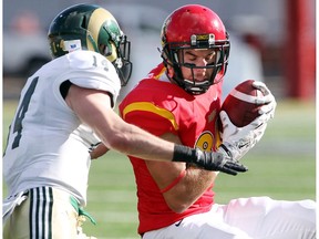 Rams defensive back Patrick MacDonald tries to bring down Dinos reciever Brett Blaszko.  The University of Calgary Dinos football team played host to the Regina Rams on October 4, 2014 winning 59-7 at  McMahon Stadium.