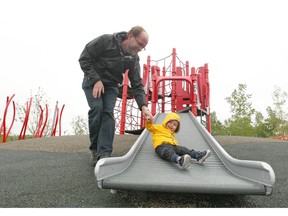 Thomas Tracey plays with his son Owen in the  playground at East Village in southeast Calgary, Alta on Saturday May 21, 2016.