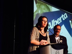 Outgoing party president Terri Beaupre and interim leader Ric McIver speak at the Progressive Conservative party's annual general meeting in Red Deer on Saturday.