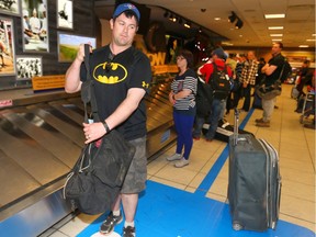 Patrick Clinton from Prince Edward Island was on the last flight from Fort McMurray and collects his bags at the Calgary International Airport in Calgary, Alta on Wednesday May 4, 2016