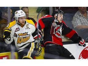 Brandon Wheat Kings' Macoy Erkamps, left, and Rouyn-Noranda Huskies' Philippe Myers collide during third period CHL Memorial Cup hockey action in Red Deer, Saturday, May 21, 2016. (Jeff McIntosh/The Canadian Press)