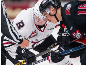 Red Deer Rebels captain Luke Philp (back) gets ready to take a face-off against Rouyn-Noranda Huskies Jean-Christophe Beaudin during a Memorial Cup game at the Enmax Centrium in Red Deer, Alta. on Sunday, May 22, 2016. Rob Wallator/ CHL Images