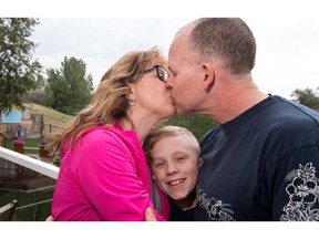 Ft. McMurray firefighter Matt Collins reunited with wife Shawna and son Ethan in Calgary, Ab., on Friday May 13, 2016. Mike Drew/Postmedia