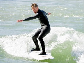 Rob Bishop surfs the Bow River near downtown Calgary. A competition in Kananaskis Country is hosting river surfers from across North America.