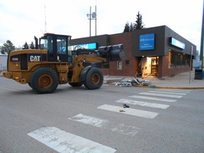 Rocky Mountain House RCMP are investigating after someone used a stolen CAT front end loader to drive through the Alberta Treasury Branch in Caroline and steal an ATM at around 4 a.m. on May 5, 2016.