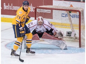 Rouyn-Noranda Huskies goalie Chase Marchand and Shawinigan Cataractes Gabriel Gagne (79) look for the puck during QMJHL President Cup action in Shawinigan, Quebec on May 10, 2016.