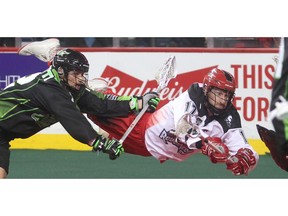 CALGARY, AB.; JANUARY 2, 2016 --  Curtis Dickson of the Calgary Roughnecks lunges for the Saskatchewan Rush net ahead of Adrian Sorichetti during their home opener Saturday night January 2, 2016 at the Saddledome. (Ted Rhodes/Calgary Herald) For Sports story by Jeff McKinnon. Trax # 00071020A